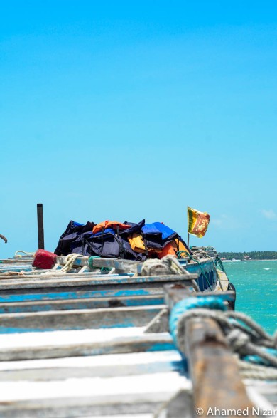 The public ferry to Delft Island is a wooden sardine can. The lifejackets are placed on the top of the boat since wearing them inside would be hazardous with everyone brushing against each other. The only thing that rises above that is the Sri Lankan flag, proudly flying on top of the ferry.  